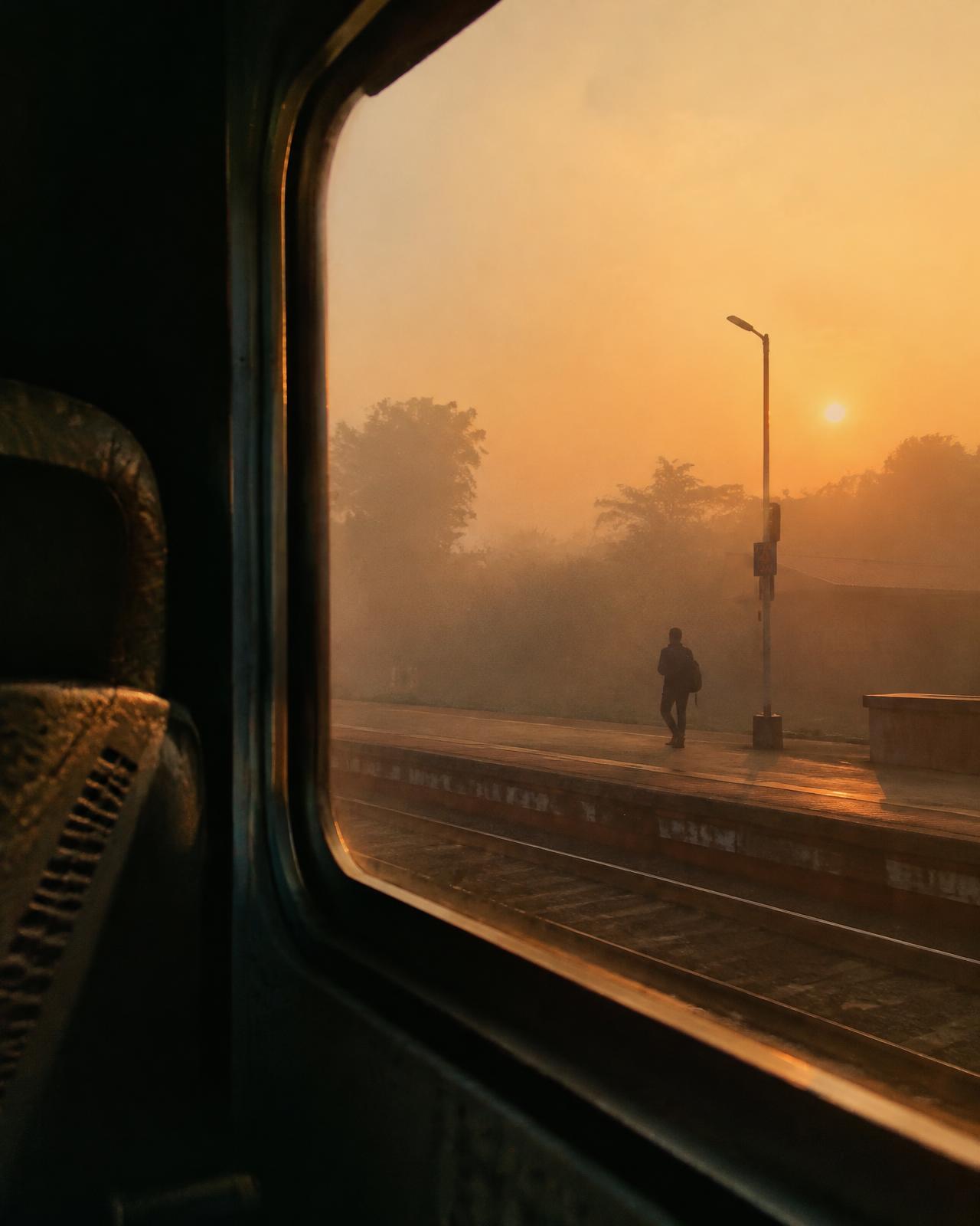 Traveller on a misty railway platform